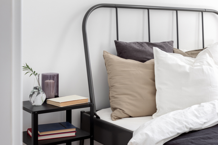 A contemporary metal bed frame, well-maintained in a calming bedroom setting.