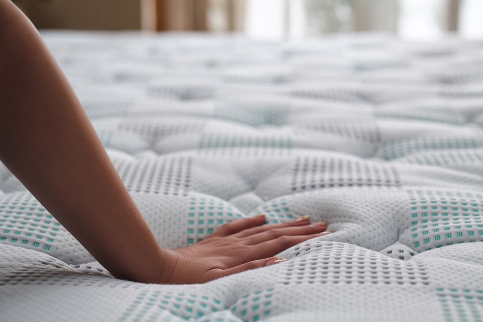 A memory foam mattress adjusting to the shape of a person lying on it, illustrating personalised support and pressure relief.
