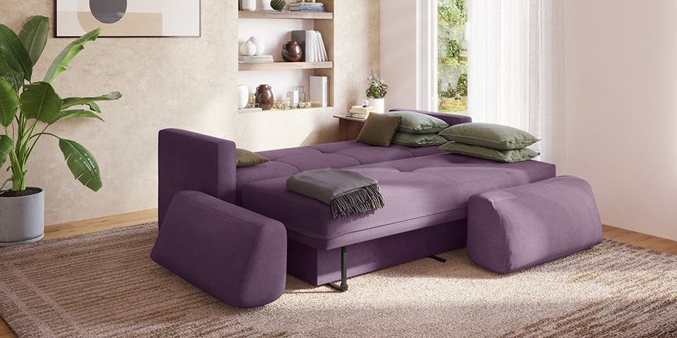Contemporary sofa-cum-bed in a modern living room, showcasing multifunctional furniture for flexible living.
