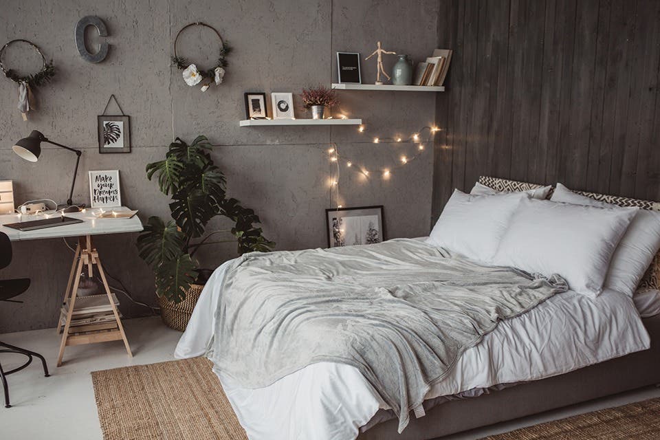 Decorated kids’ bedroom featuring fairy lights, artwork and personalised décor.