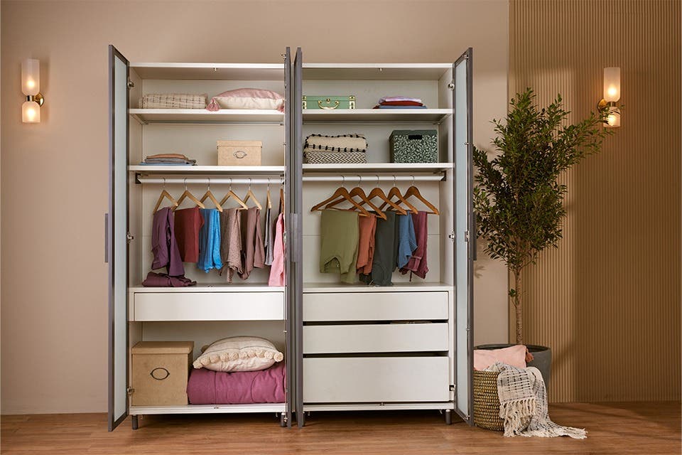 A hinged door wardrobe from Interio in a warm bedroom setting.