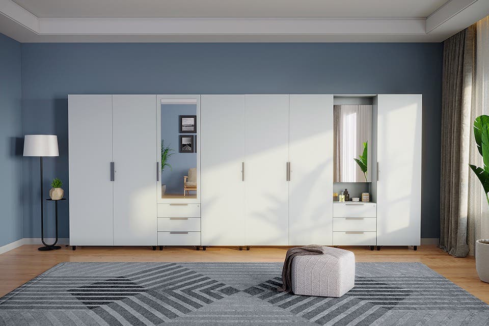 Interio’s Kreation modular wardrobe and dressers in a luxurious minimalist bedroom.