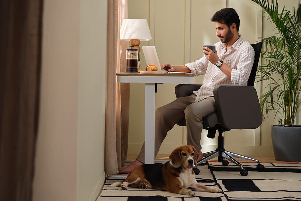  Person at a minimalist study desk and chair setup that blends well with the surroundings. 