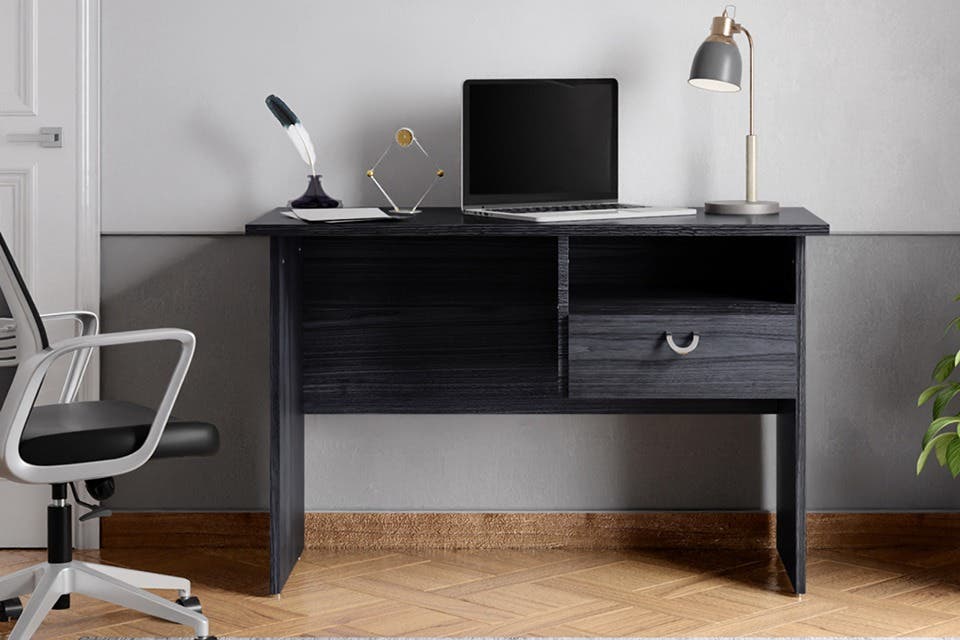 Modern black study table with drawer storage and desk accessories.