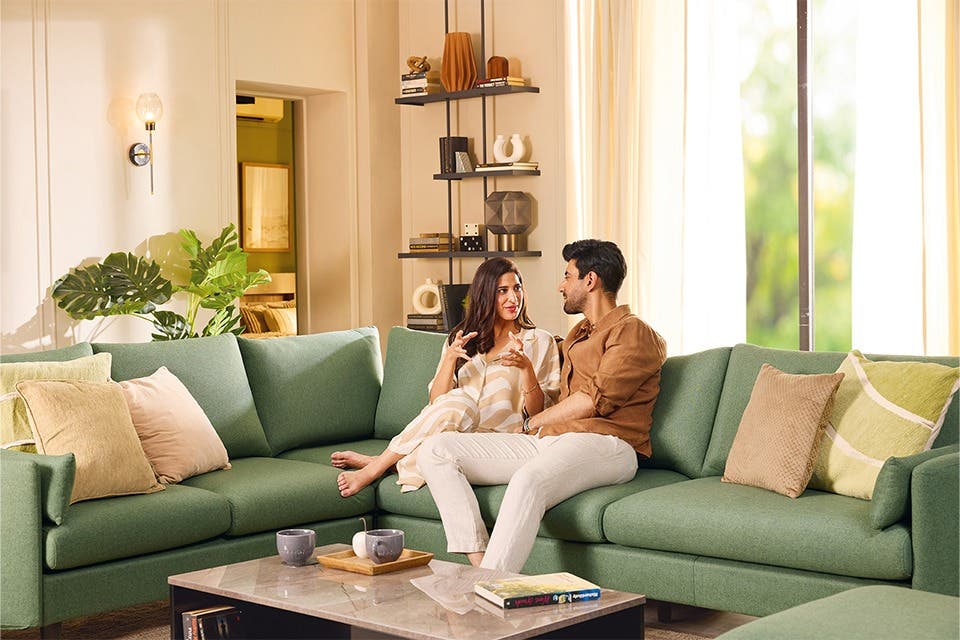 Couple in a contemporary Japandi living room with clean-lined furniture, neutral colours and minimal décor.