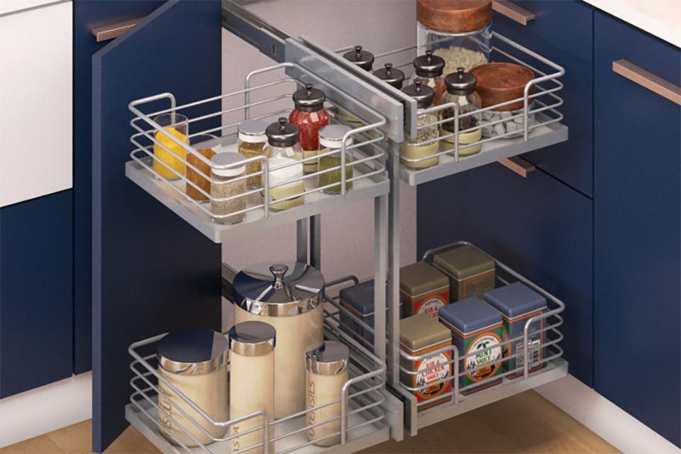 Modular kitchen with a Magic Corner pull-out storage system featuring sliding baskets for spices, pantry jars and kitchen essentials.