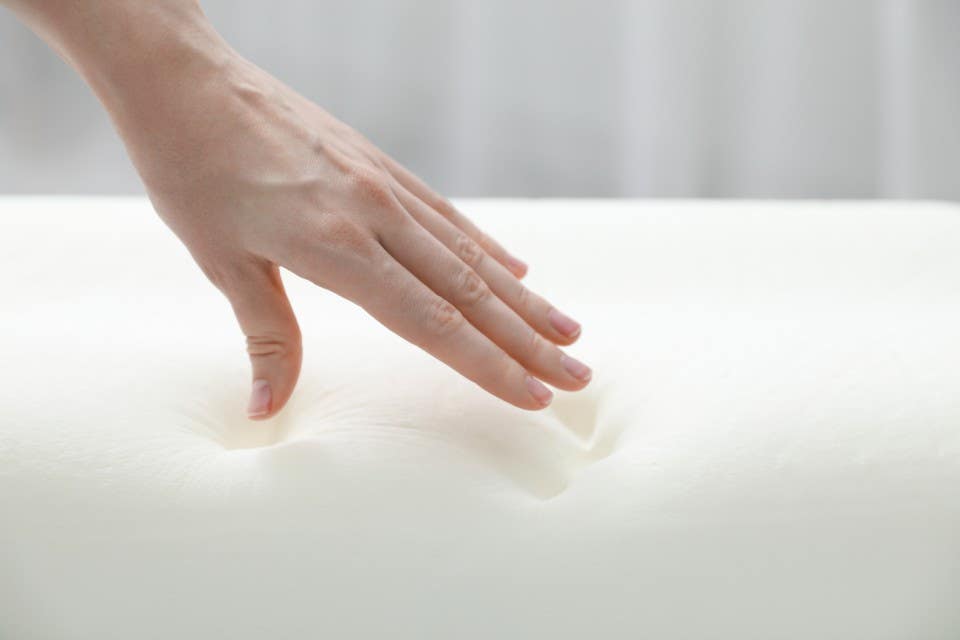 Person testing out a memory foam mattress. 