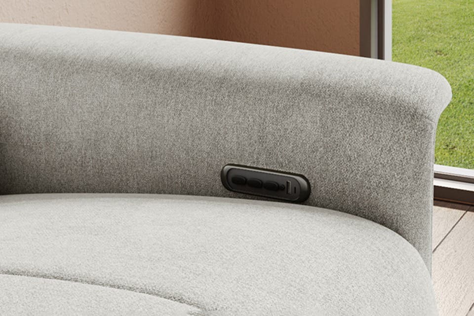 Close-up of the cushioned seats and charging ports on the TuneIn recliner.