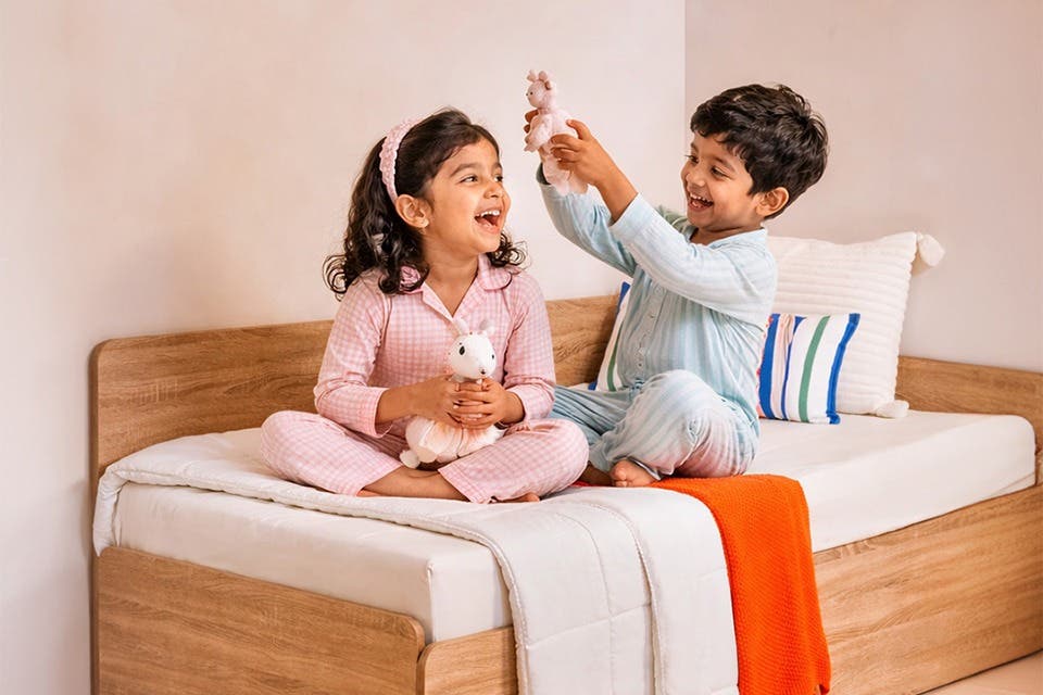 Children’s bedroom with two siblings playing on the Interio Reve bed.