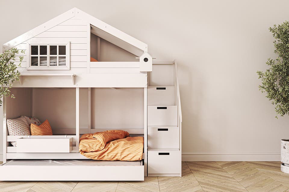 Single bed with built-in storage drawers in a children’s bedroom.