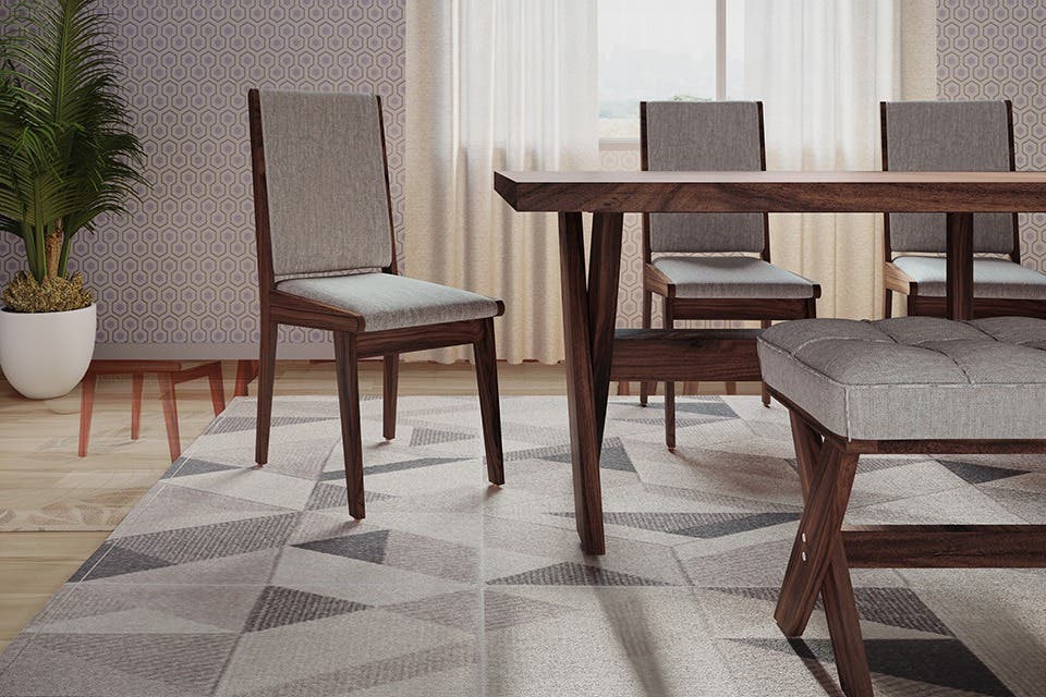 Bliss solid wood dining chair by Interio with a natural wood finish in a contemporary dining setting. 