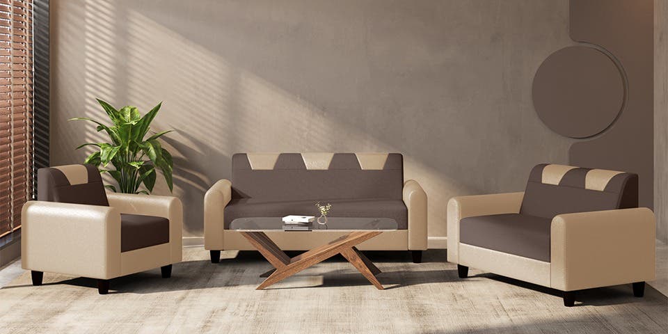 Dual-tone sofa styled against a grey wall and house plants in a contemporary living room.