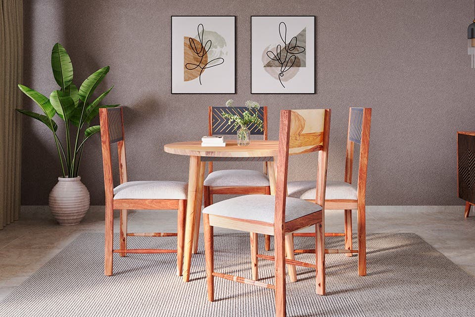 A circular four-seater dining table and a buffet table in a modern dining room.